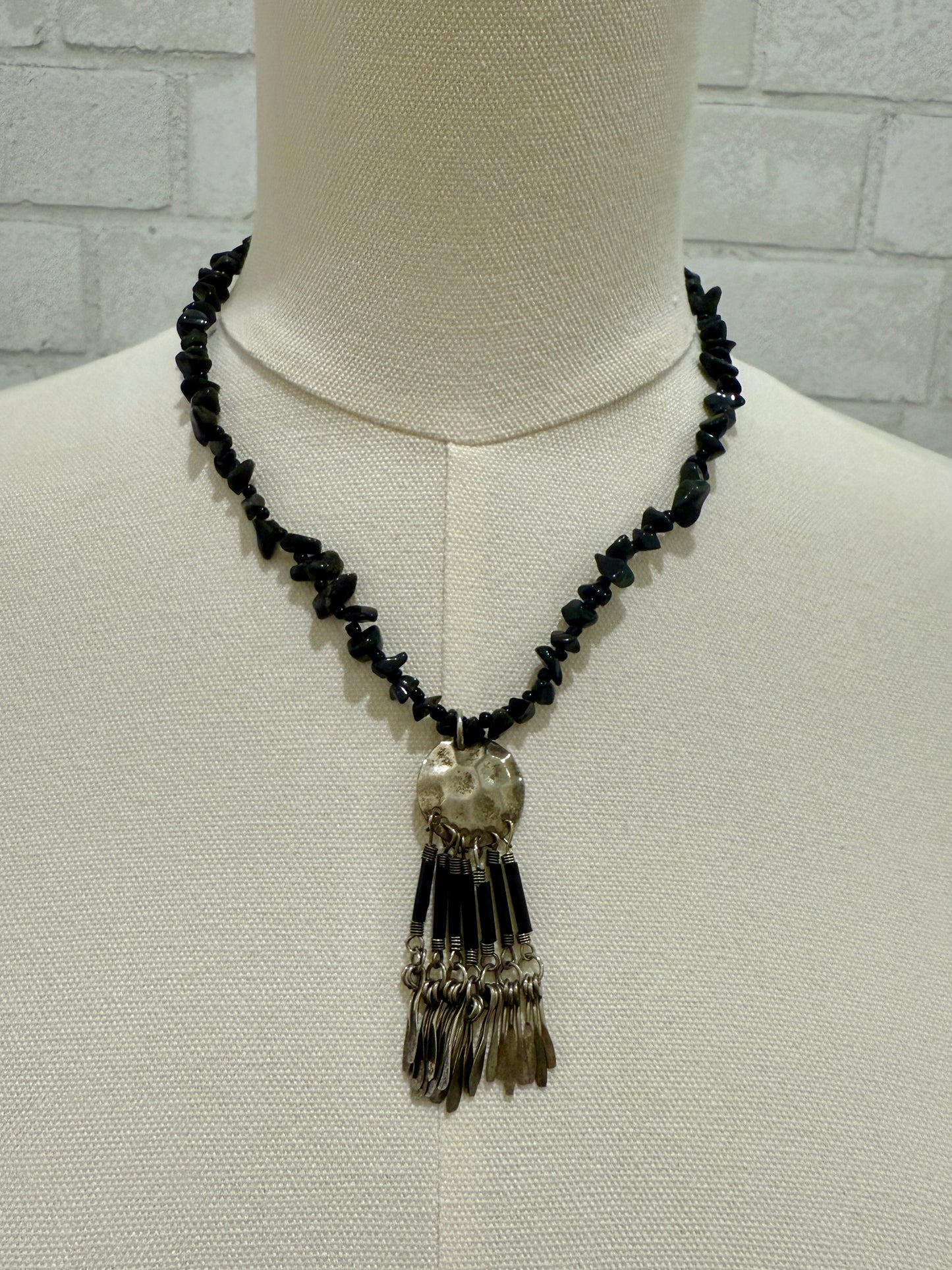 black beads and silver pendant