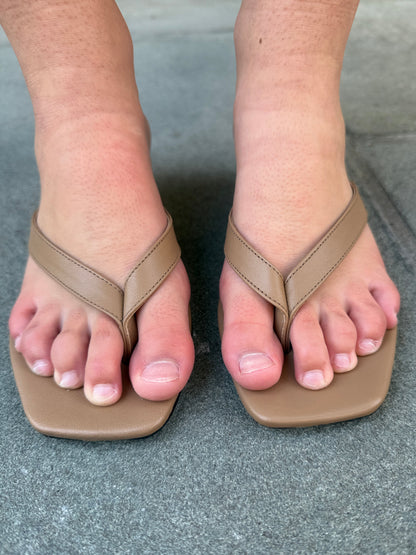 Toteme leather heeled flip flop camel on foot top view