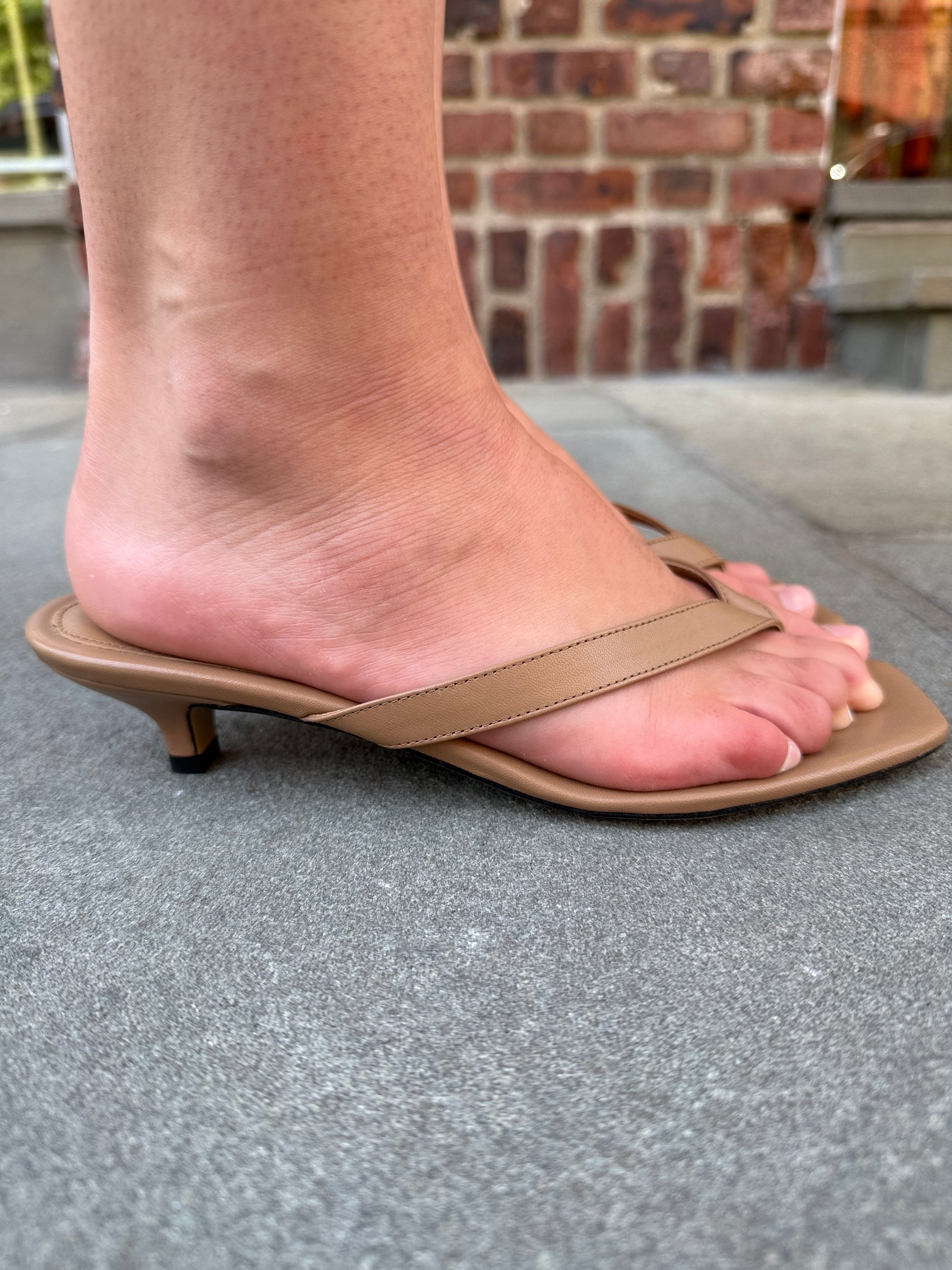 Toteme leather heeled flip flop camel on foot top view