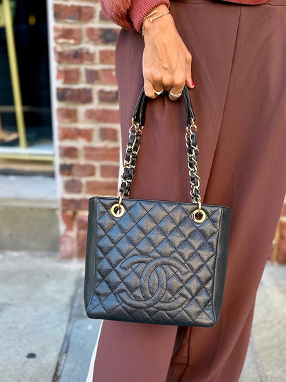 Chanel Petite Shopping Tote black caviar leather bag worn on shoulder street style Second Edition