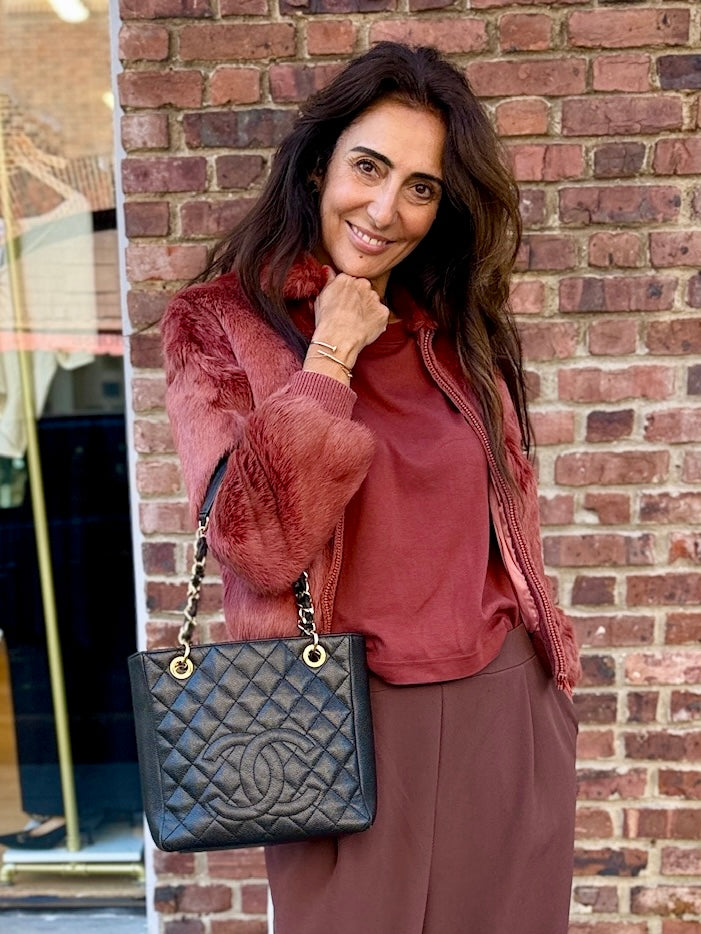 Chanel Petite Shopping Tote black caviar leather bag worn on shoulder street style Second Edition